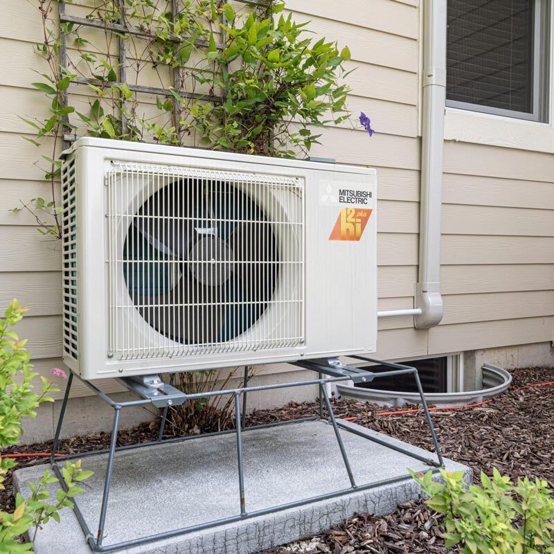 Outdoor Mitsubishi Electric heat pump unit professionally installed for energy-efficient home comfort